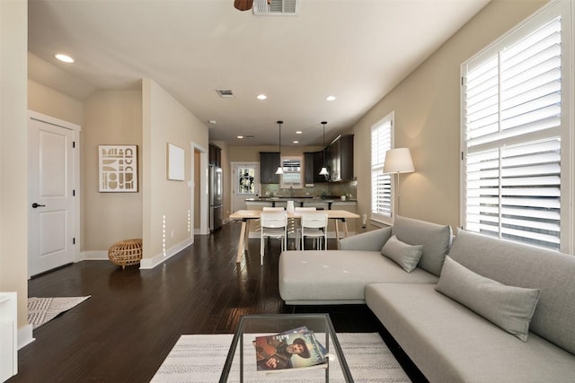 living room with dark wood-style floors, baseboards, visible vents, and recessed lighting