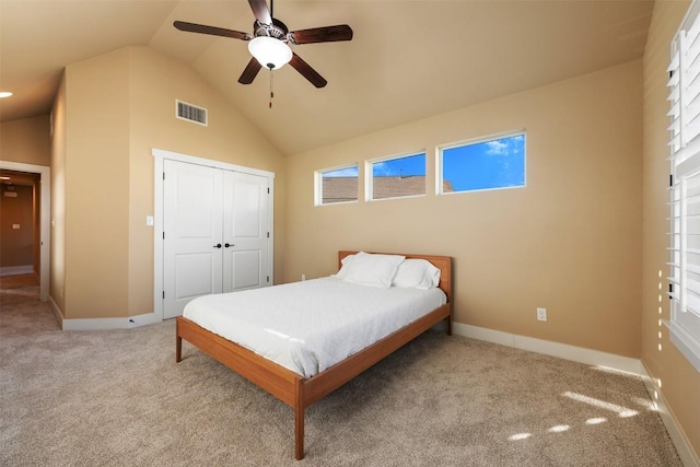 carpeted bedroom featuring a closet, visible vents, ceiling fan, high vaulted ceiling, and baseboards