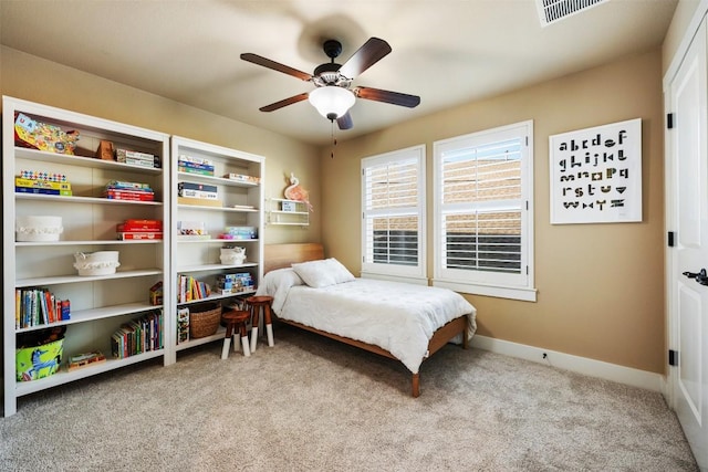 carpeted bedroom with a ceiling fan, visible vents, and baseboards