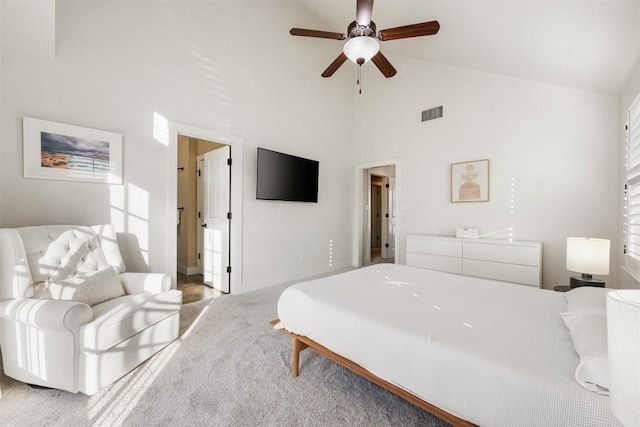 bedroom featuring visible vents, a ceiling fan, light carpet, high vaulted ceiling, and baseboards