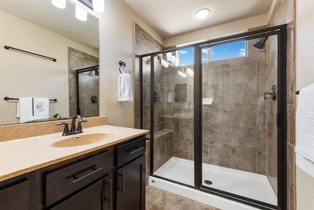 full bathroom featuring a stall shower and vanity