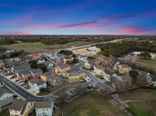 aerial view at dusk featuring a residential view