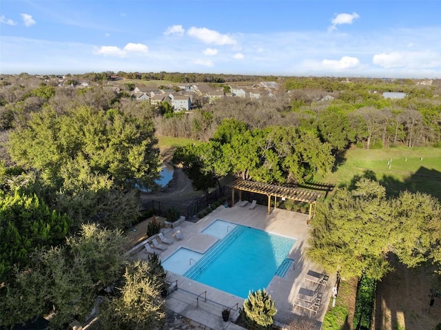 community pool with a patio area and a pergola