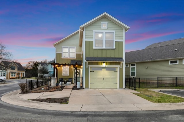 view of front of property featuring board and batten siding, fence, driveway, and an attached garage