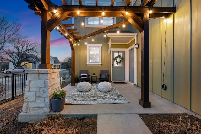 exterior entry at dusk with board and batten siding and fence