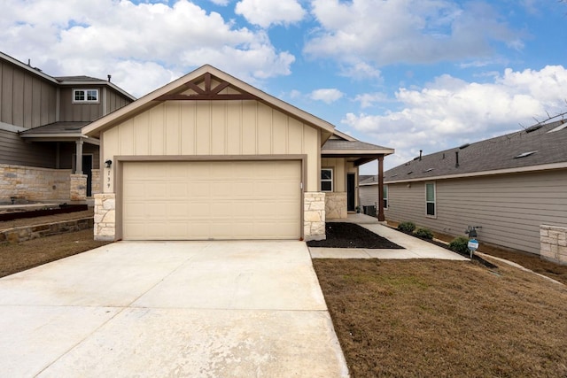 view of front of property with a garage, stone siding, board and batten siding, and concrete driveway