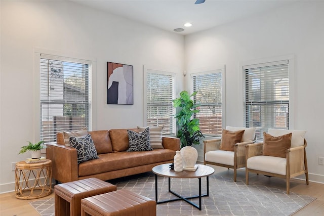 living room with baseboards, light wood-style flooring, and recessed lighting