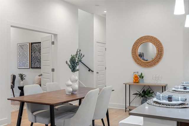 dining room with light wood-style flooring and baseboards