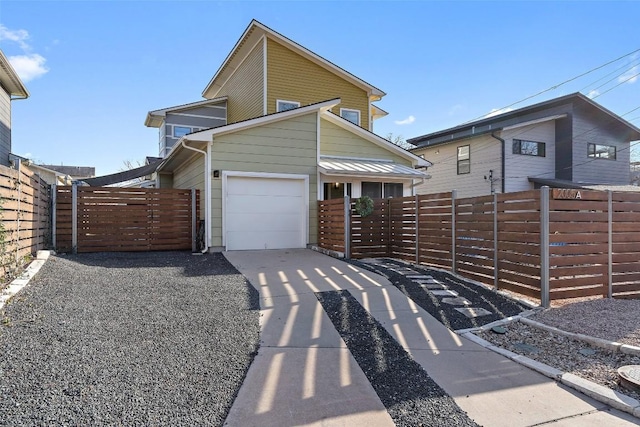 view of front facade featuring a garage, concrete driveway, and fence