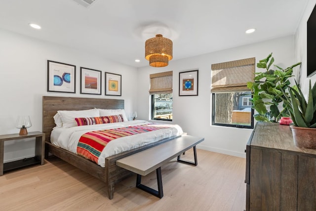 bedroom with recessed lighting, light wood-style flooring, and baseboards