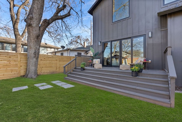 view of yard featuring fence and a wooden deck