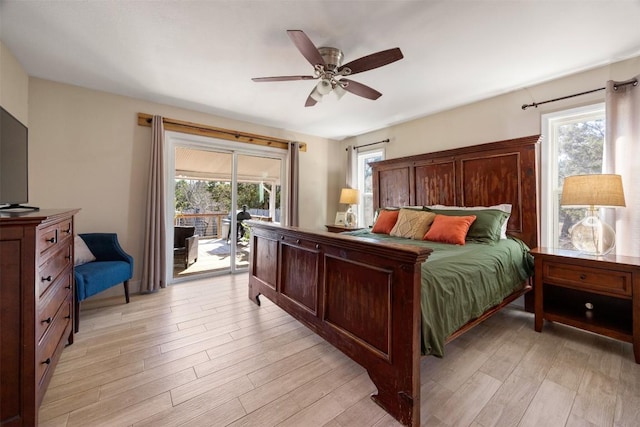 bedroom featuring access to outside, light wood-type flooring, and a ceiling fan