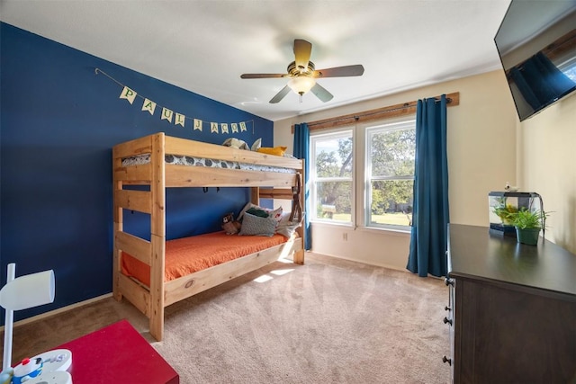 carpeted bedroom featuring ceiling fan and baseboards