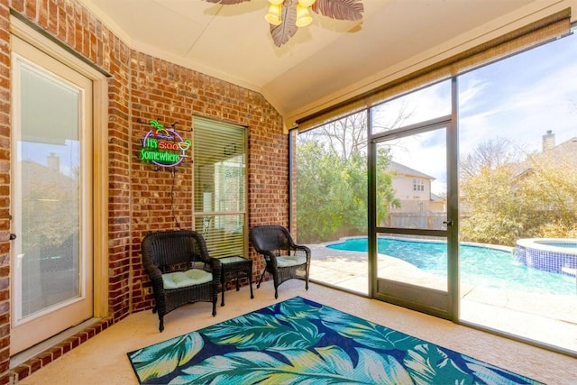 sunroom with a ceiling fan and vaulted ceiling