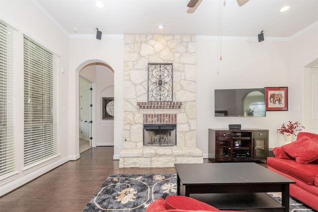 living room featuring ornamental molding, a fireplace, and wood finished floors