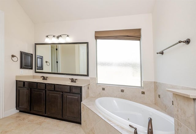 full bath with double vanity, a tub with jets, a sink, and tile patterned floors