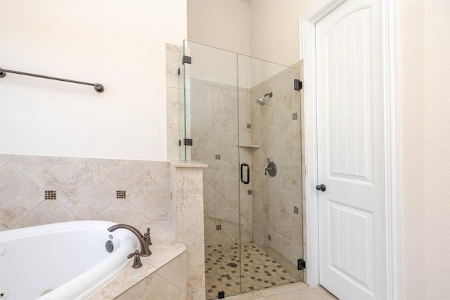 full bathroom with a garden tub and a shower stall