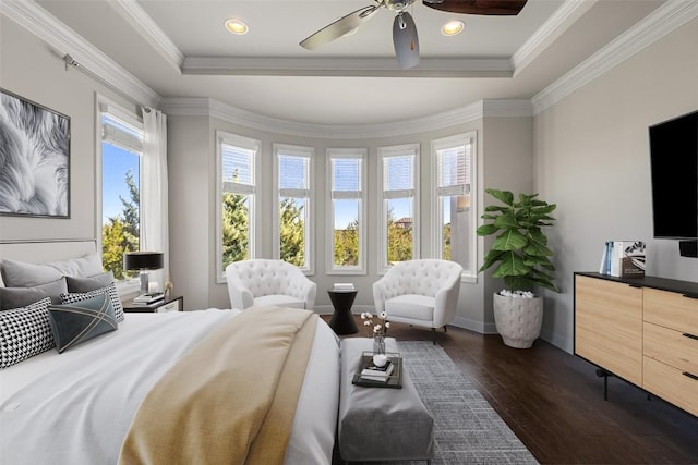 bedroom featuring dark wood-type flooring, a tray ceiling, ornamental molding, and recessed lighting