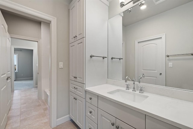 full bathroom with vanity, baseboards, and tile patterned floors