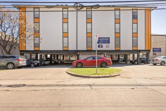 view of building exterior with uncovered parking