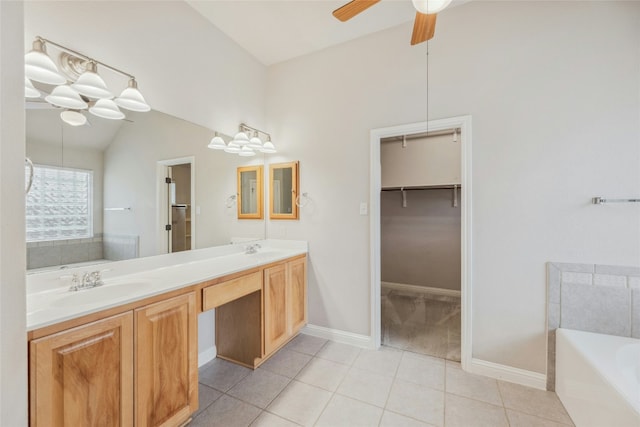 full bathroom with a garden tub, a sink, vaulted ceiling, tile patterned floors, and double vanity