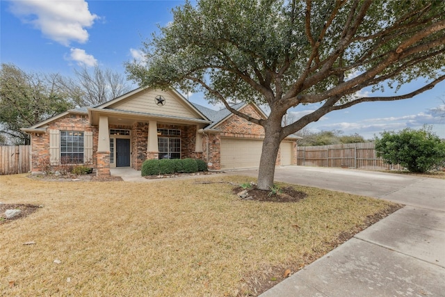 view of front facade featuring a garage, driveway, a front lawn, and fence