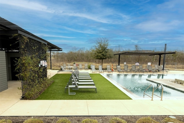 pool featuring a lawn and a patio