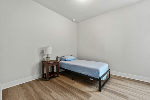 bedroom featuring light wood-style flooring and baseboards