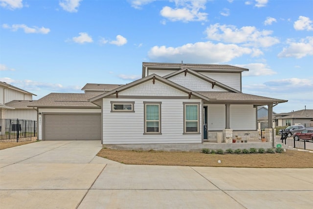 view of front of house with driveway, a porch, an attached garage, and fence