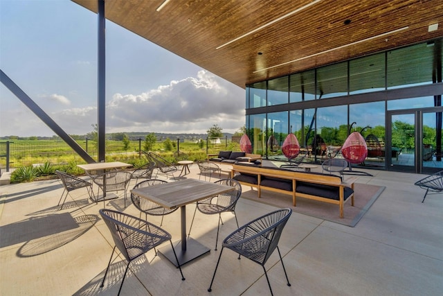 view of patio featuring a lanai