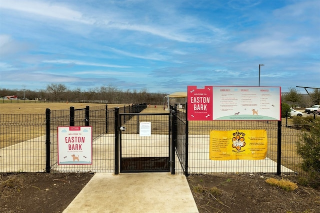 view of community with fence and a gate