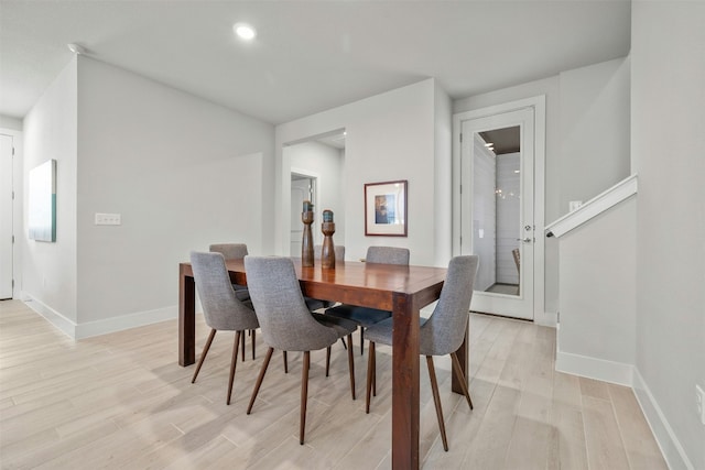 dining room with baseboards and light wood finished floors