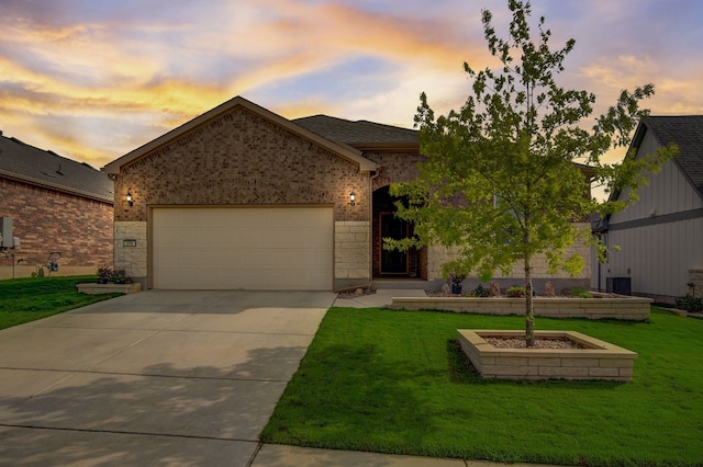 ranch-style house with a garage, driveway, a front lawn, and brick siding