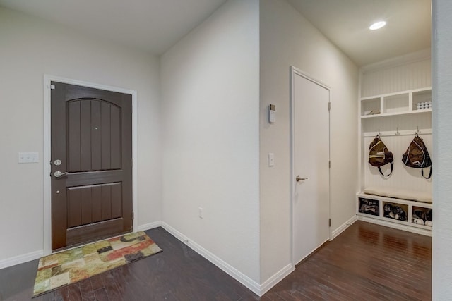 foyer featuring wood finished floors and baseboards