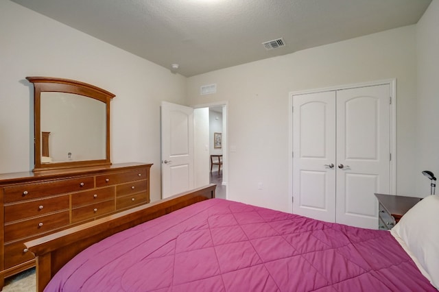 bedroom featuring a closet and visible vents