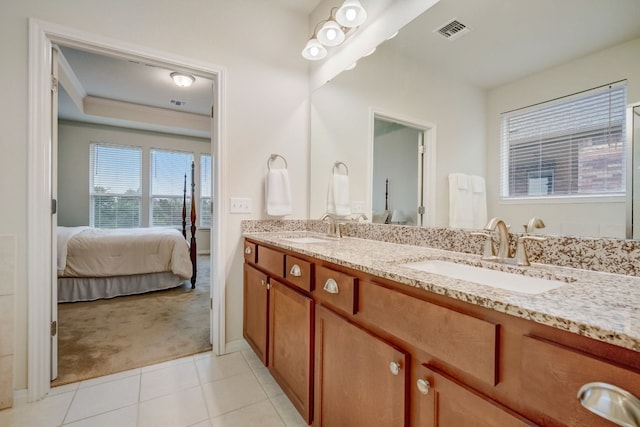 bathroom with tile patterned flooring, a sink, visible vents, and connected bathroom