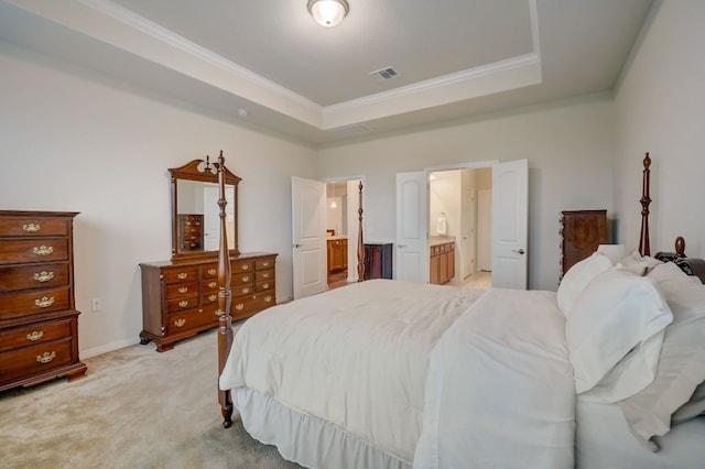 bedroom with a raised ceiling, visible vents, ornamental molding, light carpet, and ensuite bath