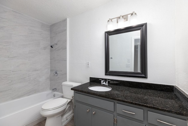 bathroom featuring shower / bath combination, a textured wall, toilet, a textured ceiling, and vanity