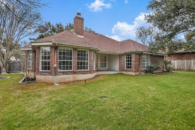 503 Riverview Dr, Georgetown, TX 78628 - rear view of house with brick siding, a chimney, roof with shingles, and a patio