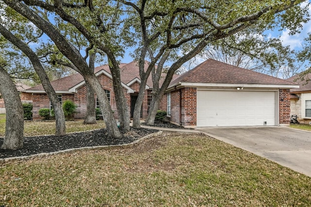 view of front facade with a garage, brick siding, driveway, roof with shingles, and a front yard