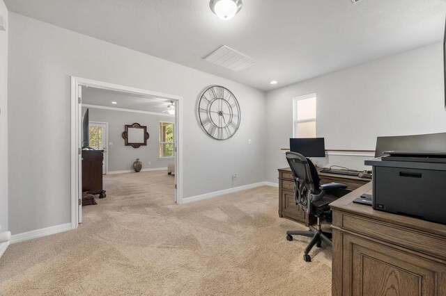 office featuring baseboards, visible vents, and light colored carpet