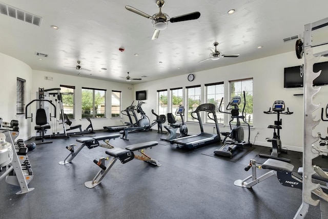 exercise room featuring visible vents, baseboards, and ceiling fan