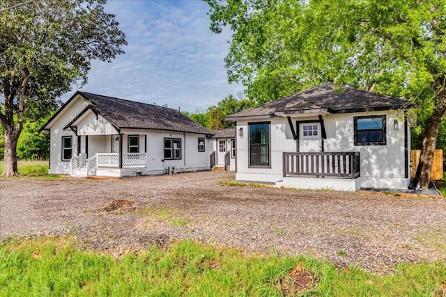 bungalow-style home featuring a shingled roof and a porch