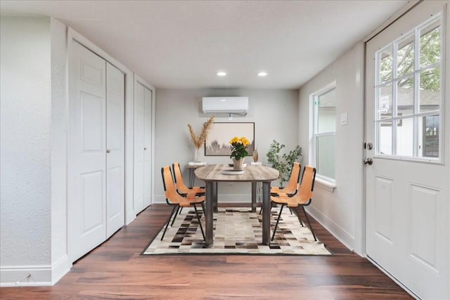 dining room featuring dark wood-type flooring, a wall mounted AC, recessed lighting, and baseboards