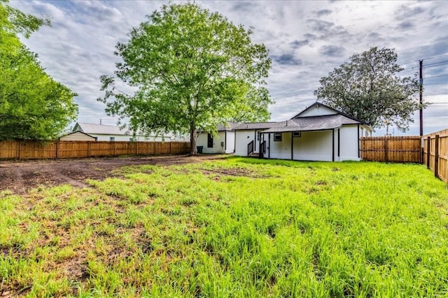 view of yard with a fenced backyard