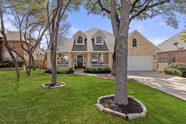 view of front of home with driveway, a shingled roof, stone siding, covered porch, and a front yard