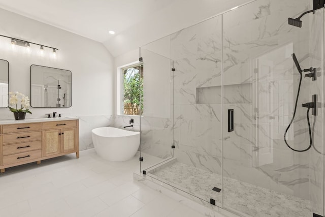 full bath featuring vaulted ceiling, a soaking tub, a marble finish shower, and vanity