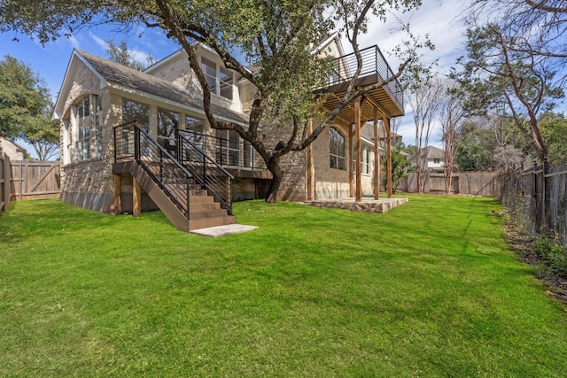 rear view of house featuring a yard, stairway, and a fenced backyard