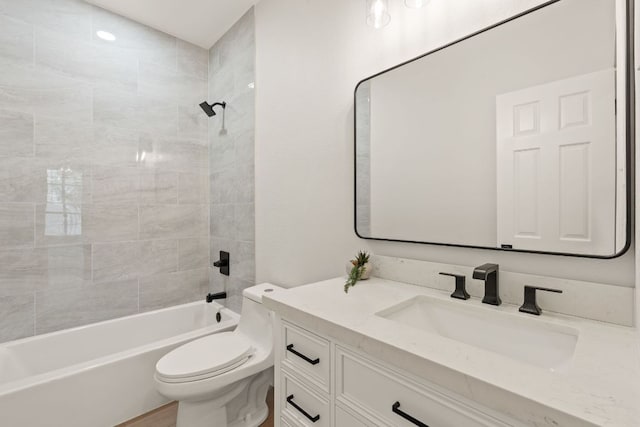 bathroom with toilet, shower / bathtub combination, and vanity