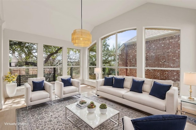 sunroom / solarium featuring lofted ceiling